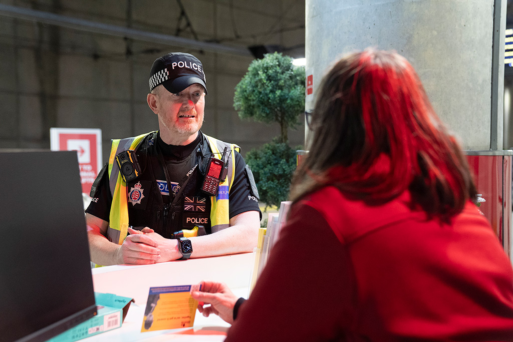 PC Sean McHale talking to staff at Stansted Airport about Project Servator