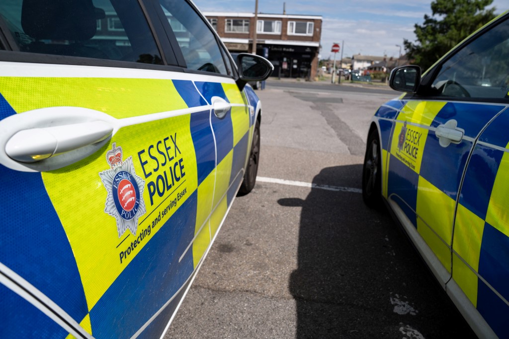 Close up of side of marked police cars parked next to each other 