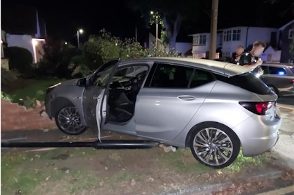 Car parked on pavement with door open
