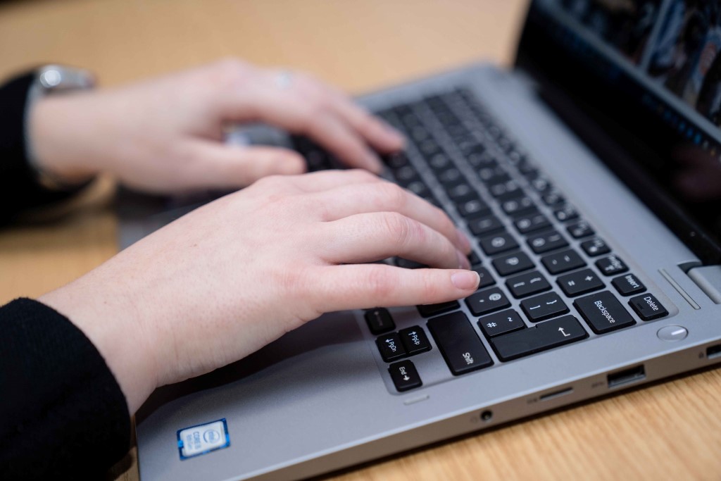 Close up on hands typing on laptop