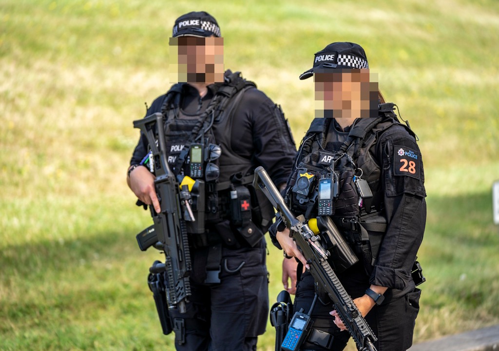 Two firearms officers holding rifles