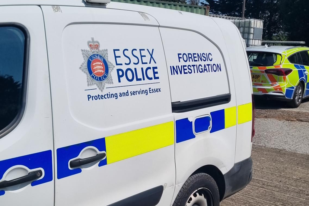 An Essex Police liveried Forensic Investigation van, parked in front of an Essex Police liveried police car