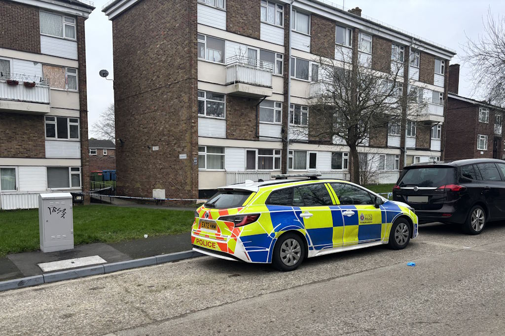A police car parked close to a cordon