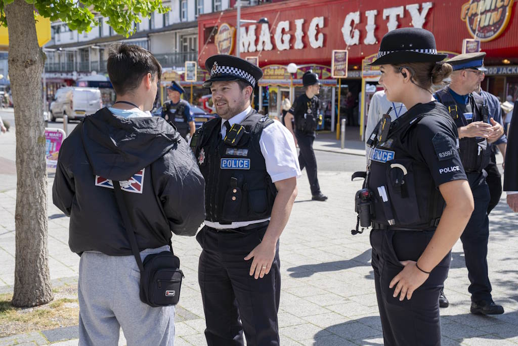 Two uniformed officers speaking to a member of the public in Clacton