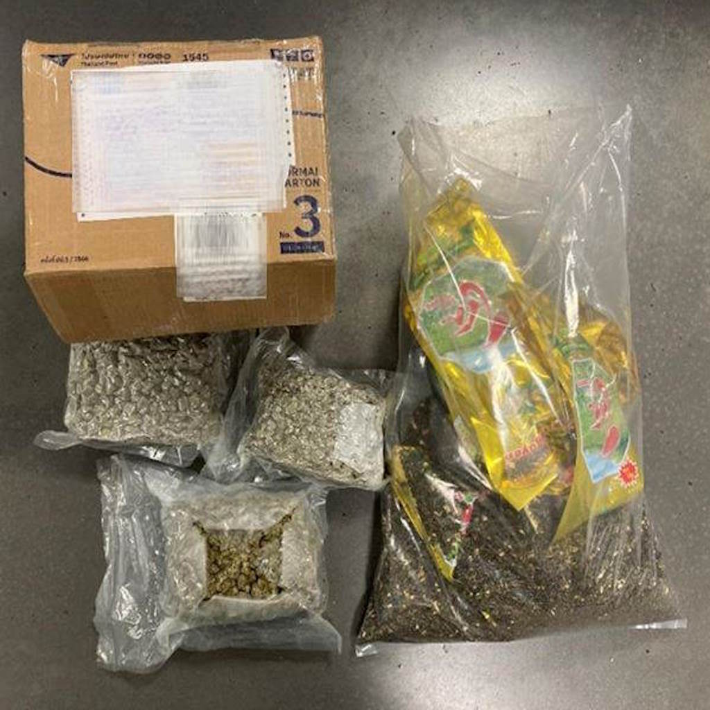 Packages of cannabis alongside brown parcel