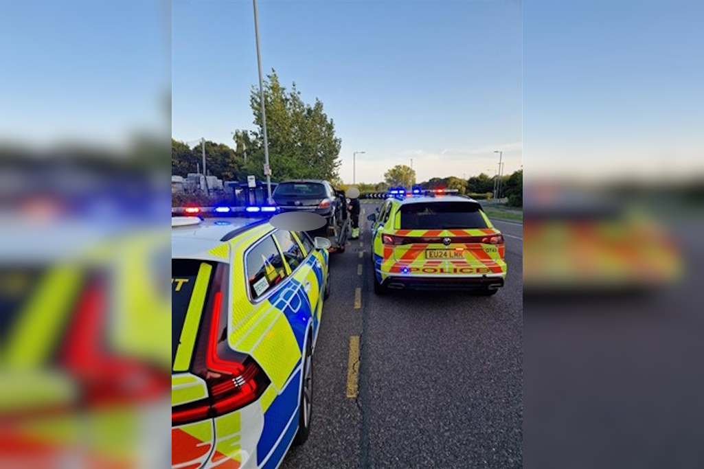 Two police cars stop vehicle