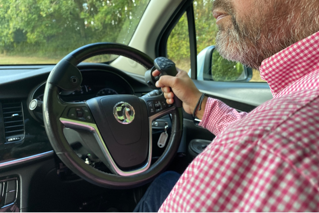 Driver at wheel of car with adaptation