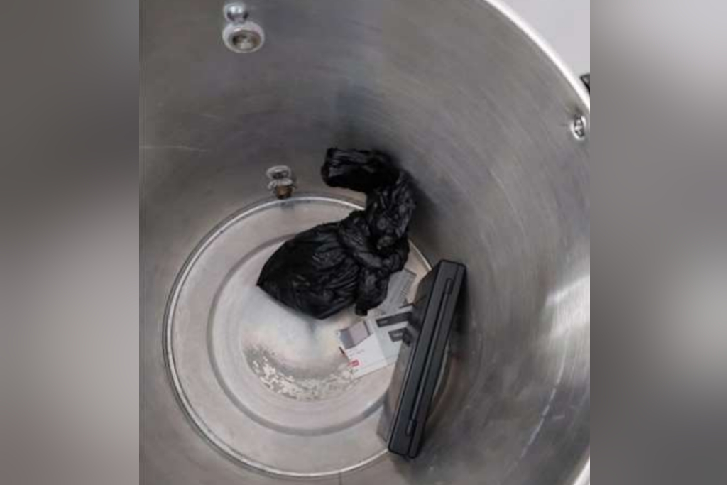 A black bag, containing what was later discovered to be cocaine, sits next to a set of scales nestling in the bottom of a tea urn