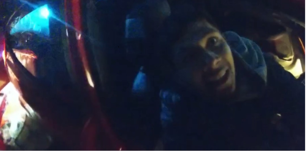 Man in car leaning through window
