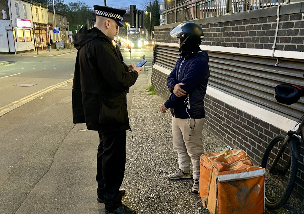 A delivery rider is stopped and arrested.