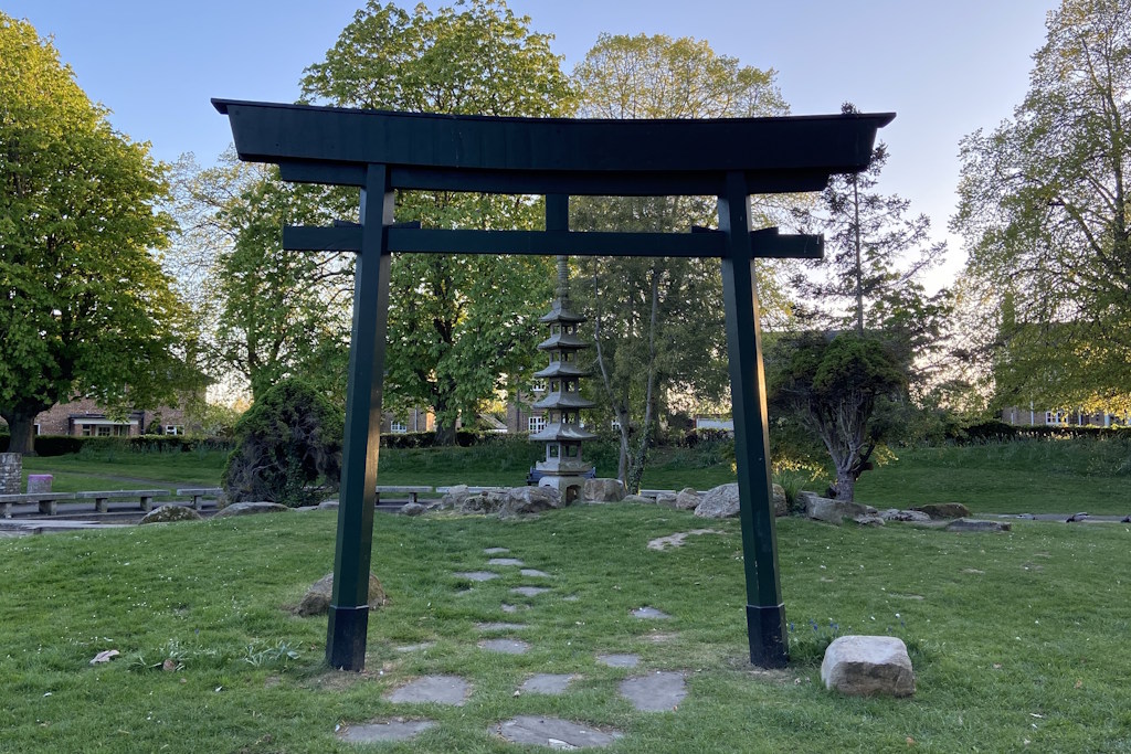 An iron Japanese Torii gate standing at the entrance to a shrine