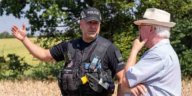 RET Officer speaks to member of the public on farmland