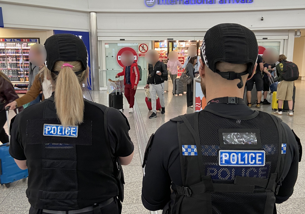 Two officers at Stansted Airport arrivals