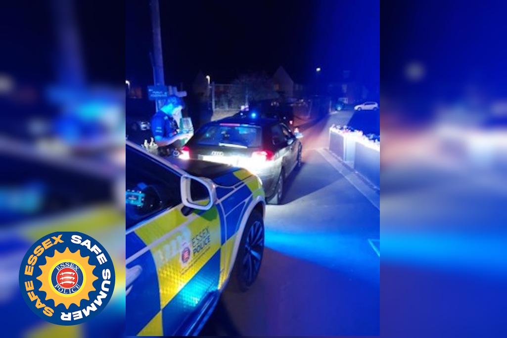 Police officer stops car at garage