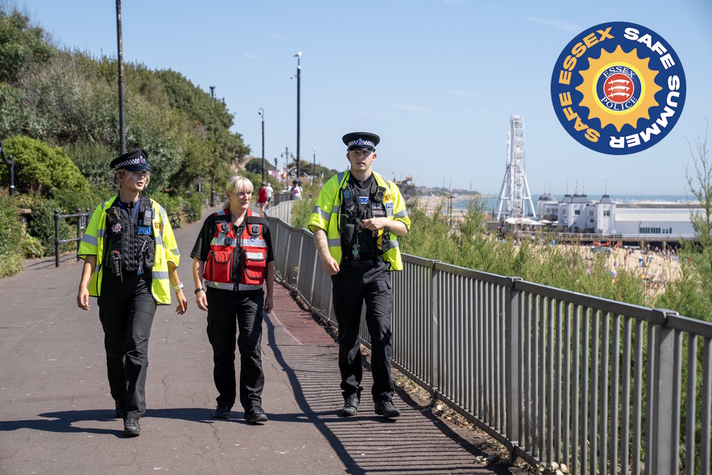 Two uniformed Essex Police neighbourhood policing officers patrolling along a seafront with a uniformed Tendring District Council community safety officer