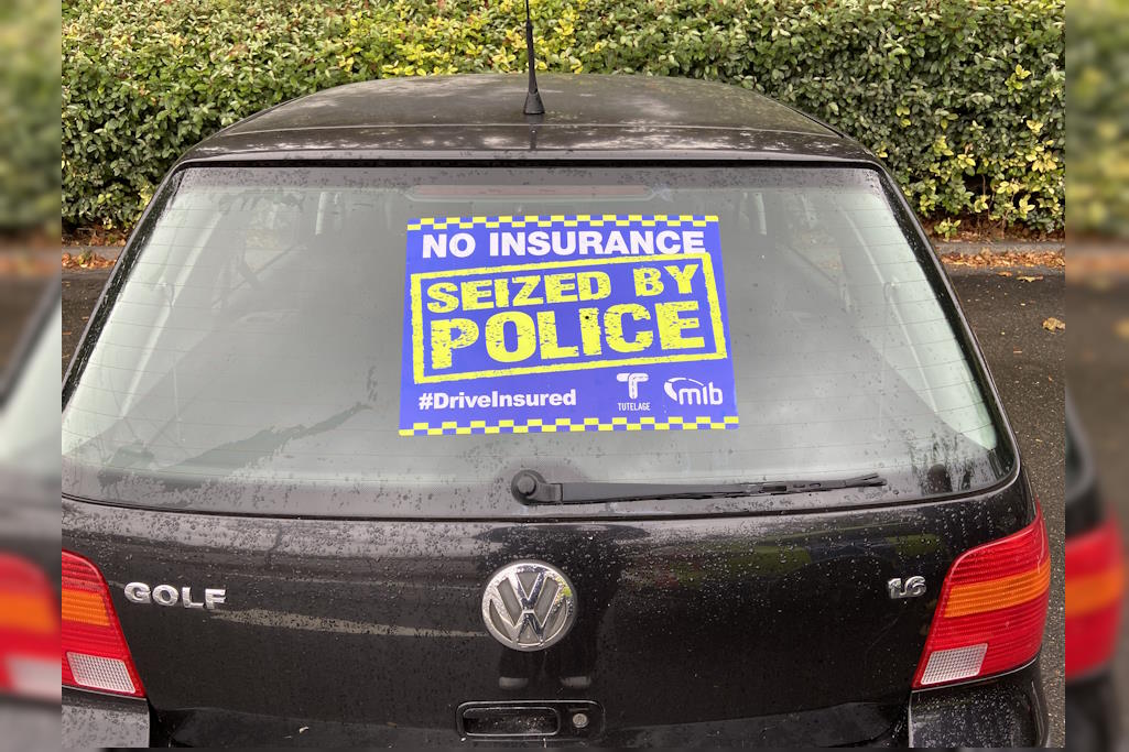 Black car with  seized sticker on window