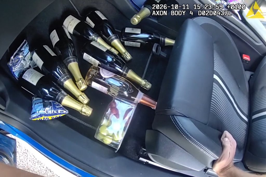 Essex Police body-worn video footage showing eight bottles of Champagne, one bottle of Prosecco, two packets of crisps and a pack of grapes in the passenger footwell of a car 